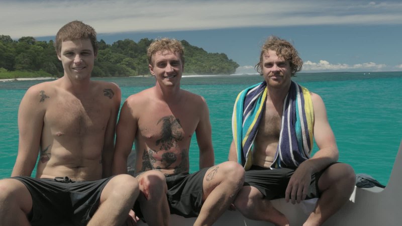 Three guests enjoying a boat day beside the islands