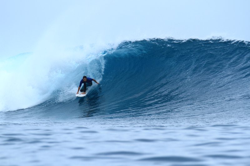 Secret Left: A surfer riding a wave in the Banyak Islands
