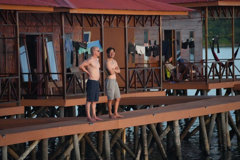 Friends on the overwater walkway in the evening light
