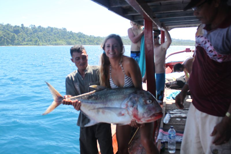 Guests and crew celebrating their catch aboard the boat